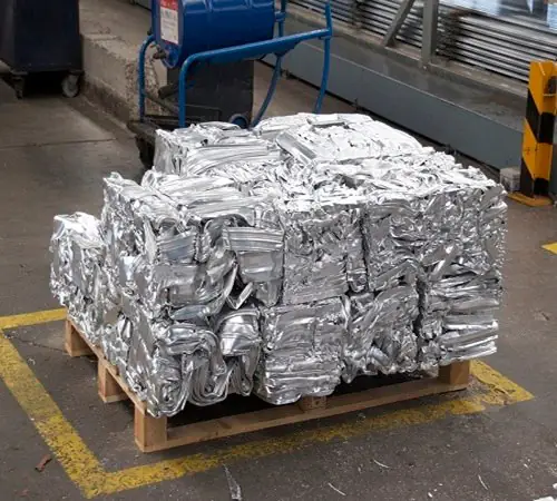 Compressed bales of 6063 aluminium extrusion scrap on a pallet